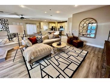 Spacious living room featuring a sectional sofa, large area rug, and open floor plan at 5992 Genovese Ave, Las Vegas, NV 89141