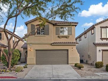 Charming two-story home with a two-car garage, desert landscaping, and neutral-toned stucco in a residential neighborhood at 6178 Pisan Ln, Las Vegas, NV 89148