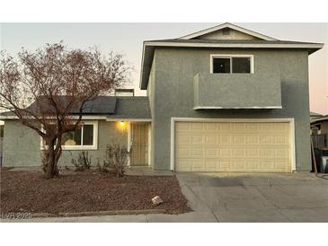 Two-story house featuring solar panels and a beige garage door at 6240 Viewpoint Dr, Las Vegas, NV 89156