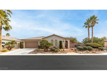 Single-story home with landscaped yard and two-car garage at 6422 Hughes Springs Dr, Las Vegas, NV 89131