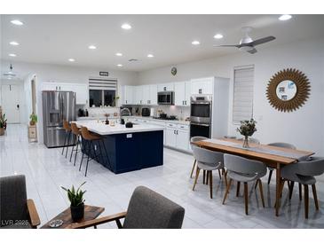 Spacious kitchen with island, stainless steel appliances, and breakfast bar at 7129 Flora Lam St, Las Vegas, NV 89166