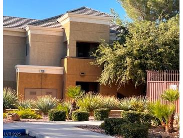 Multi-level home with lush landscaping and a well-maintained exterior at 8070 W Russell Rd # 2068, Las Vegas, NV 89113