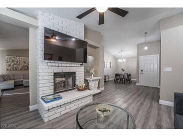 Spacious living room with fireplace and gray sectional sofa at 8233 Ducharme Ave, Las Vegas, NV 89145