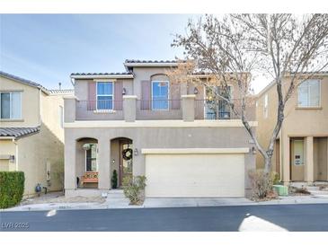 Two-story house with attached garage and balcony at 8415 Quarentina Ave, Las Vegas, NV 89149