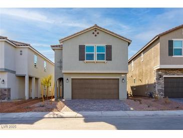 Two-story house with brown garage door and gray exterior at 4143 Juniper Pear Ave, Las Vegas, NV 89141