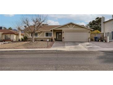 Single-story home with attached two-car garage and landscaped front yard at 750 Willow Ave, Henderson, NV 89002