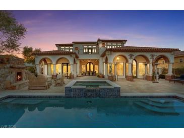 Luxury home with pool, spa, and expansive patio at dusk at 22 Rue Grimaldi Way, Henderson, NV 89011