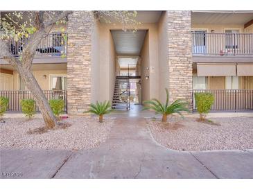 Building exterior showcasing a walkway, staircase, and landscaping at 5060 Indian River Dr # 377, Las Vegas, NV 89103