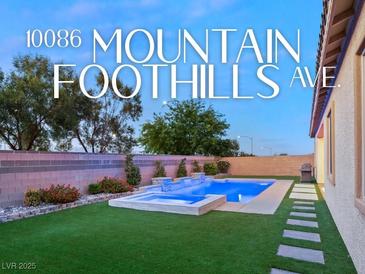 Stunning backyard oasis featuring a sparkling pool, spa, and lush landscaping at 10086 Mountain Foothills Ave, Las Vegas, NV 89149