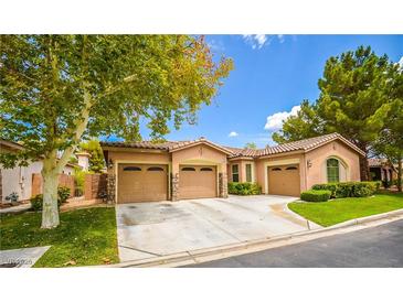 Single-story house with two-car garage and landscaped yard at 10718 Del Rudini St, Las Vegas, NV 89141