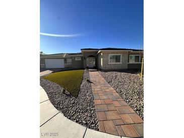 Single-story home with stone accents and a landscaped walkway at 2580 Bonano Ct, Las Vegas, NV 89108