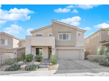 Two-story house with stone accents and landscaped front yard at 2598 Iron Crest Ln, Las Vegas, NV 89138