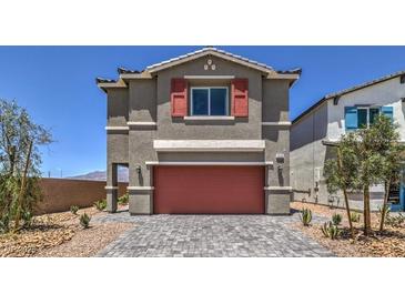 Two-story house with gray siding, red garage door, and landscaping at 2637 Snapdragon Falls Ave # 105, North Las Vegas, NV 89081