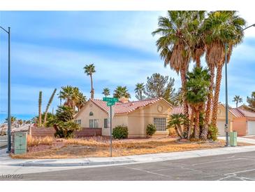 Single-story house with a landscaped yard and palm trees at 4416 Inez Dr, Las Vegas, NV 89130