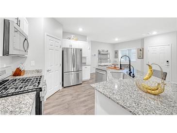 Modern kitchen with stainless steel appliances and granite countertops at 4655 Fuchsia Nights Ave # 103, North Las Vegas, NV 89084