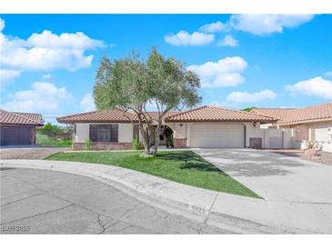 Single story home with a two-car garage and landscaped front yard at 5423 Arturo Ct, Las Vegas, NV 89120