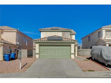 Two-story house with a green garage door and a landscaped front yard at 6536 Elk Creek Ln, Las Vegas, NV 89156