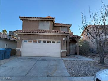 Two-story house with attached garage and front walkway at 7329 Restful Springs Ct, Las Vegas, NV 89128