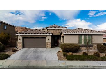 Single-story home with two-car garage and landscaping at 788 Flowing Meadow Dr, Henderson, NV 89014