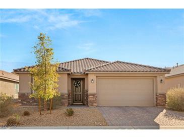 Single-story home with tile roof, neutral color scheme, and a two-car garage at 8113 Brown Clay Ave, Las Vegas, NV 89113