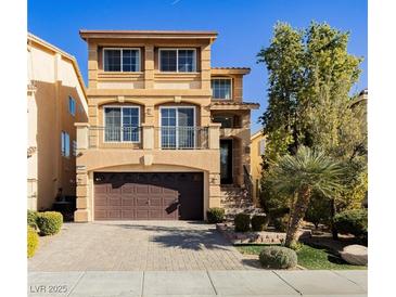 Two-story house with a brown door and attached garage at 8428 Summers Ranch Ct, Las Vegas, NV 89139