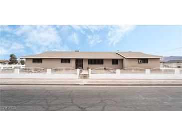 Ranch style home with brick facade and a well-manicured lawn at 845 Palo Verde Dr, Henderson, NV 89015