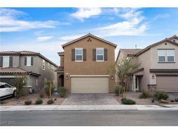 Two-story house with tan exterior, two-car garage, and landscaping at 2932 Torreon Ln, Las Vegas, NV 89121