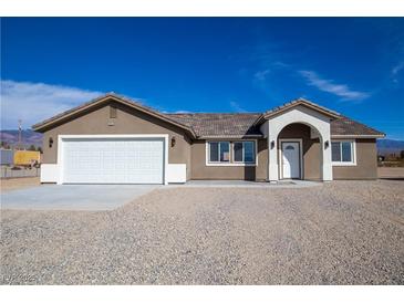 Charming single-story home featuring a spacious front yard and attached two-car garage at 5841 Genoa Ave, Pahrump, NV 89060