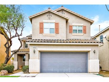 Two-story house with attached garage and landscaping at 989 Crescent Falls St, Henderson, NV 89011