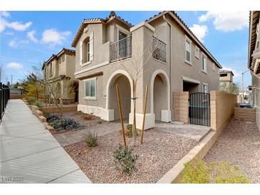 Two-story house with attractive landscaping and a paved walkway at 10691 Sariah Skye Ave, Las Vegas, NV 89166