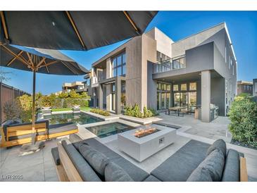 Luxury home with a stunning pool, patio, and fire pit at 10896 Tranquil Hills Way, Las Vegas, NV 89135