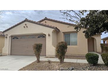 Single-story home with a two-car garage and desert landscaping at 4290 S Gressa St, Pahrump, NV 89061