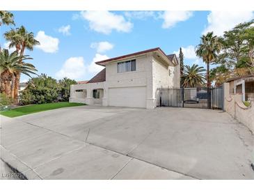 Two-story house with a large driveway and gated entrance at 4330 Flandes St, Las Vegas, NV 89121