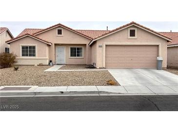 Single-story house with a two-car garage and desert landscaping at 4618 Zia Ridge St, North Las Vegas, NV 89031