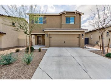 Two-story house with a two-car garage and landscaping at 521 Abrazar Ave, North Las Vegas, NV 89081