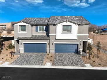 Two-story home with attached garages and landscaped front yard at 6542 Coffee Theme St # Lot 12, North Las Vegas, NV 89084