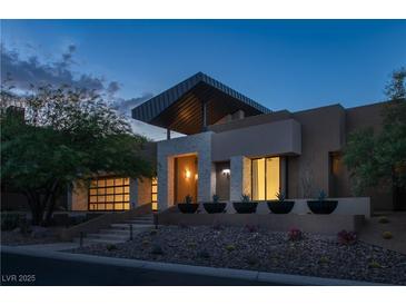 Modern home with sleek design, stone accents, and landscaped grounds at 78 Hawk Ridge Dr, Las Vegas, NV 89135