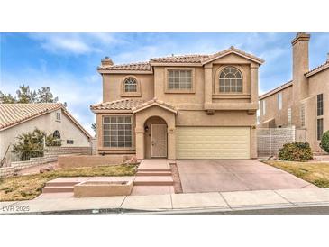 Two-story house with beige exterior, attached garage, and landscaping at 86 Myrtle Beach Dr, Henderson, NV 89074