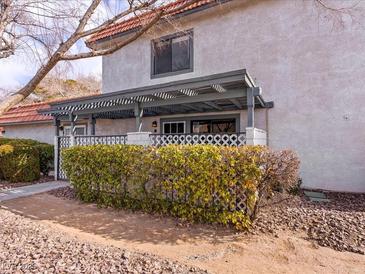 Inviting exterior with a covered patio and well-manicured landscaping at 1008 Willow Tree Dr # B, Las Vegas, NV 89128