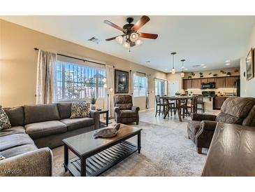 Spacious living room with comfortable seating and large windows at 10260 Danskin Dr, Las Vegas, NV 89166