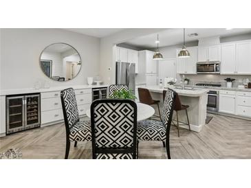 Modern kitchen with stainless steel appliances, a wine fridge, and stylish chairs at 104 Alamere Falls Dr, Las Vegas, NV 89138