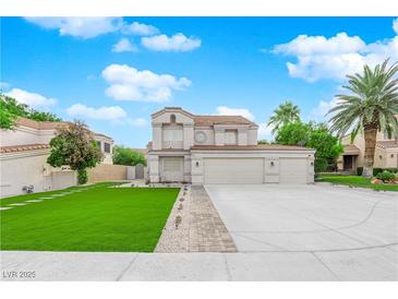 Two-story house with a three-car garage and a landscaped front yard at 1837 Birdie Ln, Henderson, NV 89074