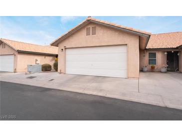 Attached single car garage with a white door and neutral colored exterior at 312 Crosswind Way, Las Vegas, NV 89145