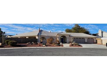 Single-story home with tile roof, landscaped yard, and attached garage at 3540 E Burgundy Dr, Pahrump, NV 89048