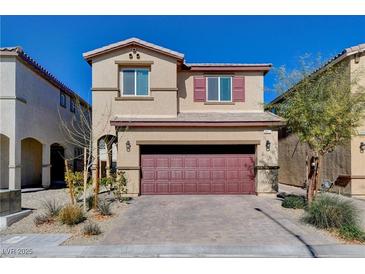 Inviting two-story home features a brick driveway and a striking red-colored garage door at 3812 Seyfert Ave, North Las Vegas, NV 89084