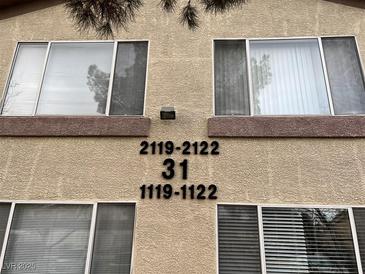 Tan building exterior with multiple windows and unit numbers visible at 5710 E Tropicana Ave # 2122, Las Vegas, NV 89122