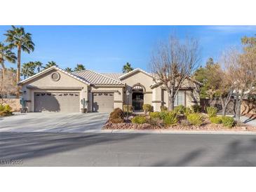 Single-story house with three-car garage, mature landscaping, and desert landscaping at 7220 Elderly Ave, Las Vegas, NV 89131