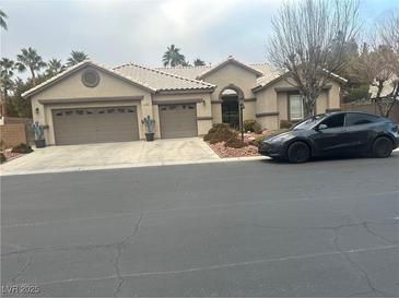 Single-story house with three-car garage and landscaped front yard at 7220 Elderly Ave, Las Vegas, NV 89131