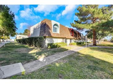 Charming townhome featuring a unique roofline and mature landscaping at 3473 Monte Carlo Dr, Las Vegas, NV 89121