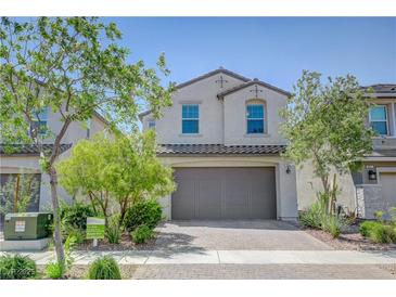 Charming two-story home showcasing a well-manicured front yard and neutral color palette at 365 Andy Wheeler Dr, Henderson, NV 89011